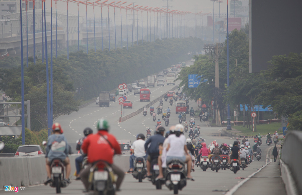 Người dân di chuyển trong bầu không khí mờ ảo ở Xa lộ Hà Nội. Giữa trưa nhưng khung cảnh như sáng sớm.