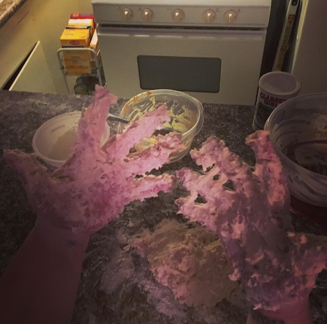 Bột dính đầy găng tay trong lúc nhào.