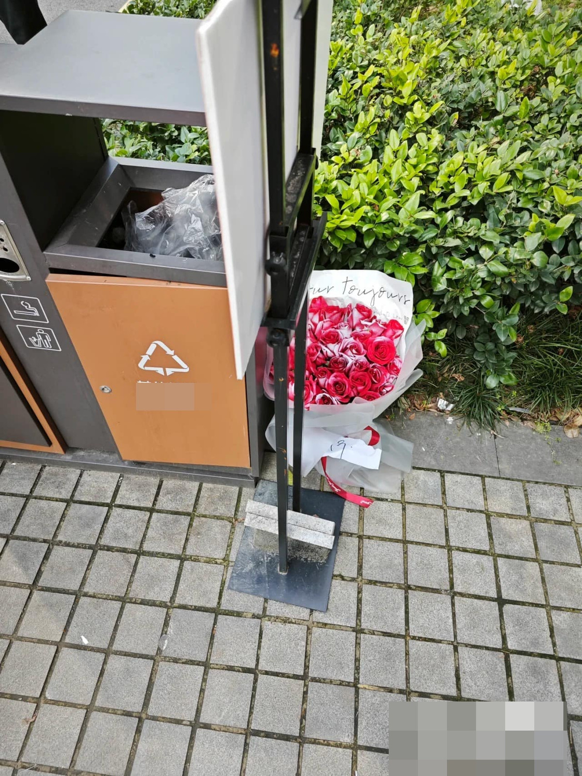 Bó hoa xinh đẹp được đặt ngay ngắn bên cạnh thùng rác, dự báo có mối tình nào đó đã tan vỡ.