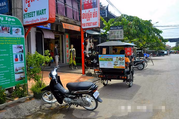 Dãy hàng quán san sát nhau trên con đường dẫn tới chợ ở Campuchia. Ảnh Sina