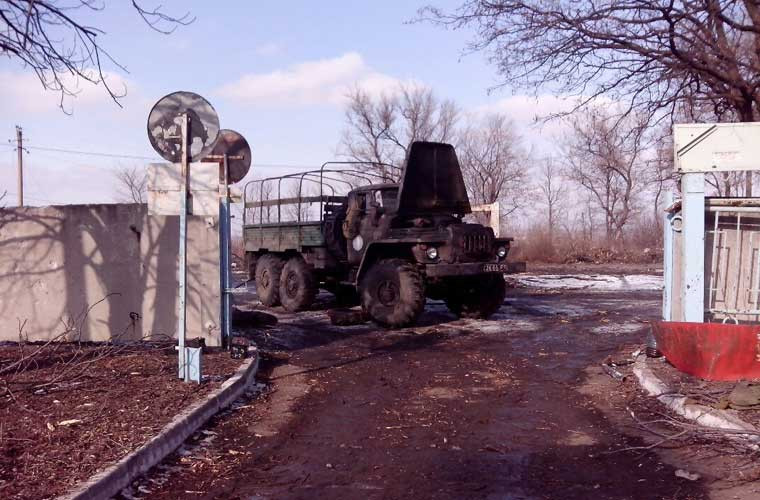 Một chiếc xe vận tải chở quân bị phá hỏng, bỏ lại bên ngoài một căn cứ.