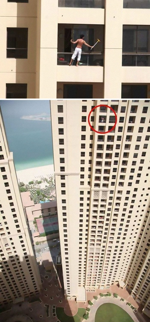 Không hề có dây bảo hiểm, người đàn ông này lau cửa kính bằng cách bám vào cánh cửa