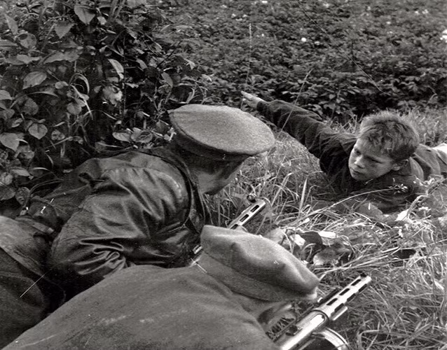 Một bé trai báo cho các binh sĩ biết vị trí của lính Đức Quốc xã năm 1943. Ảnh: VT.