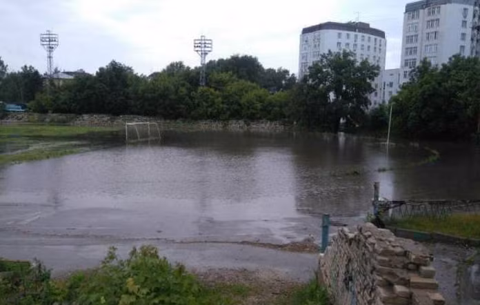 Sân bóng biến thành ao nước sau trận mưa lớn. Ảnh: ER.