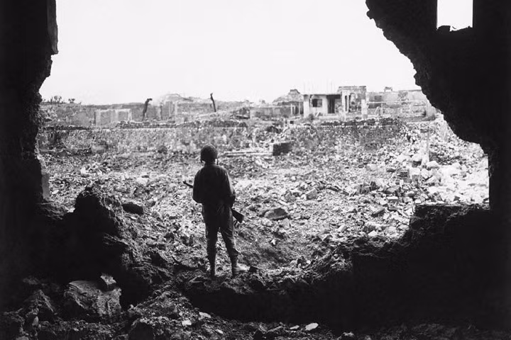 Một lính thủy quân lục chiến quan sát hậu quả của một đợt oanh tạc do Mỹ tiến hành nhằm vào thành phố Naha vào ngày 13/6/1945. Nguồn ảnh: AP.