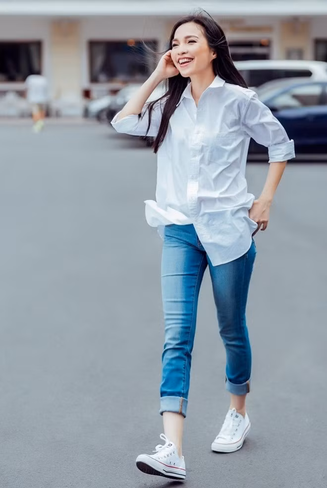 Hiền Thục không cần cầu kỳ sang chảnh. Nữ ca sĩ vẫn ghi điểm tuyệt đối khi mix sơ mi trắng với quần jean và giầy thể thao đầy năng động trẻ trung ngày đầu đông. Ảnh: Chanh Nguyễn.