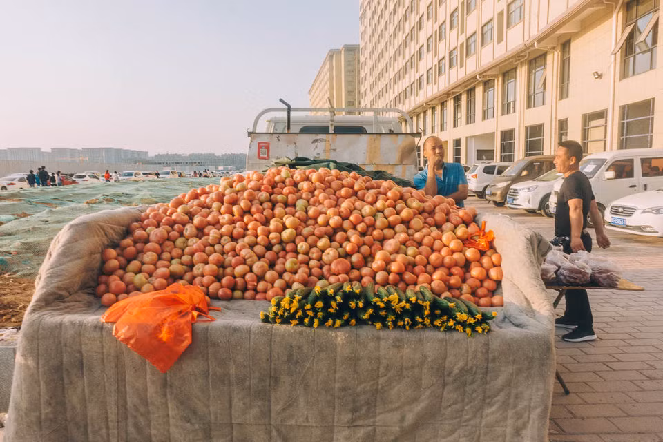 Những người nông dân đến từ các ngôi làng gần đó mang rau củ quả đến bán cho công nhân nhà máy Foxconn.