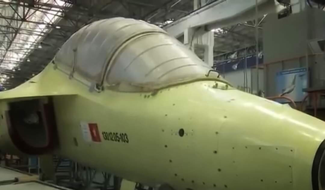 Mới đây, những hình ảnh đầu tiên về tiêm kích phản lực huấn luyện hiện đại hàng đầu thế giới này của Không quân ta đã chính thức lộ diện trên kênh truyền hình quốc gia Nga - Russian-1. Chiếc máy bay mang quốc kỳ Việt Nam trên khung thân chứng tỏ đây chính là chiếc Yak-130 thuộc lô 12 chiếc mà ta đặt mua từ nước bạn. Có thể thấy rằng tiêm kích này đã sản xuất gần như là hoàn tất chỉ thiếu radar ở mũi và sơn màu. Ảnh: Chiếc Yak-130 của Việt Nam tại nhà máy Nga. Ảnh: Chụp màn hình kênh Russia-1.