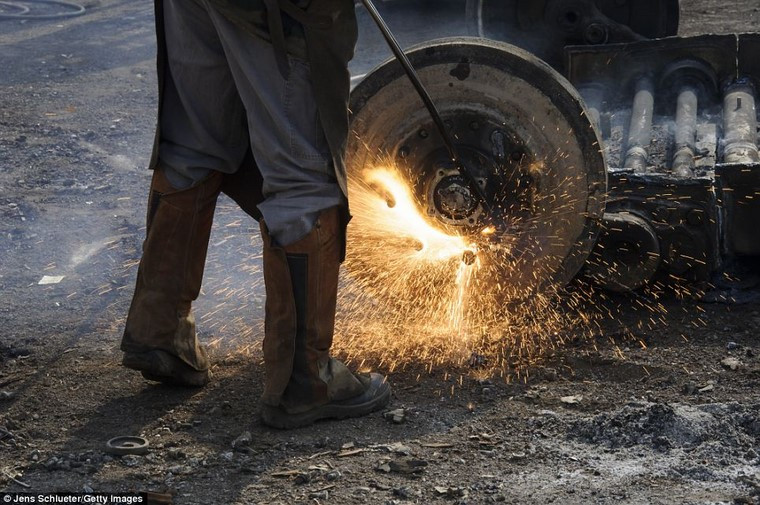 Một thợ cơ khí đang cắt bánh xe thiết giáp chiến đấu Marder.