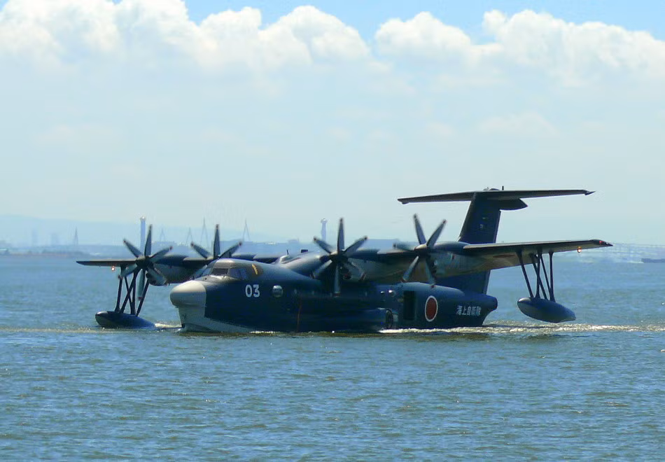 US-2 vốn là loại thủy phi cơ do Nhật Bản phát triển nhằm để thay thế các thủy phi cơ US-1. Loại phương tiện này mới được đưa vào hoạt động chính thức trong năm 2007.