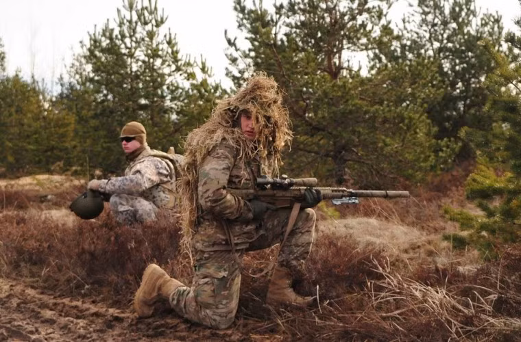 Trong ảnh là các binh sĩ Mỹ được xe thiết giáp Stryker đưa tới địa điểm chiến đấu. Trong ảnh, binh sĩ ngụy trang áo cỏ đang cầm trên tay khẩu súng bắn tỉa bán tự động M110 SASS có khả năng tiêu diệt mục tiêu từ 800m.