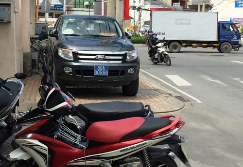 Xe công vụ đậu trên vỉa hè đường Kha Vạn Cân, quận Thủ Đức, trước trụ sở Đội Thanh tra xây dựng địa bàn quận Thủ Đức, dù khu vực này luôn là điểm nóng về việc trật tự đô thị đi thu dọn người dân buôn bán lấn chiếm vỉa hè.