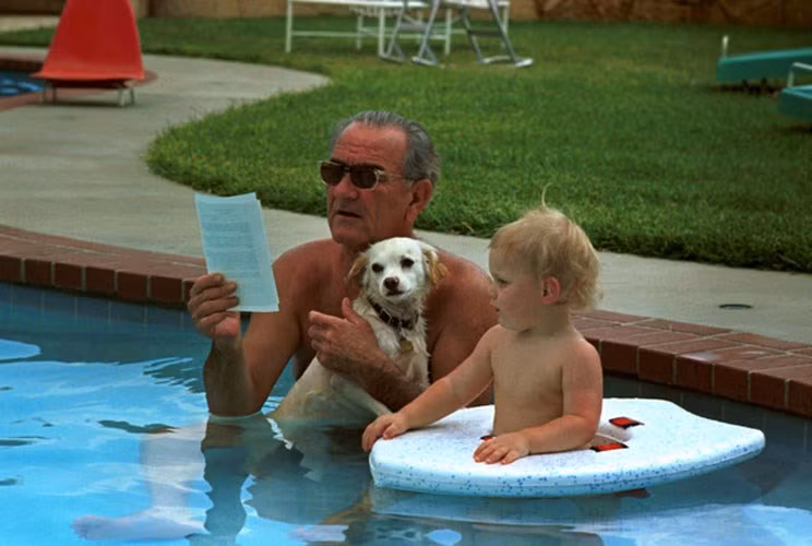 Tổng thống Lyndon B. Johnson ôm chú cún cưng Yuki tắm cùng cháu trai trong hồ bơi của Nhà Trắng.