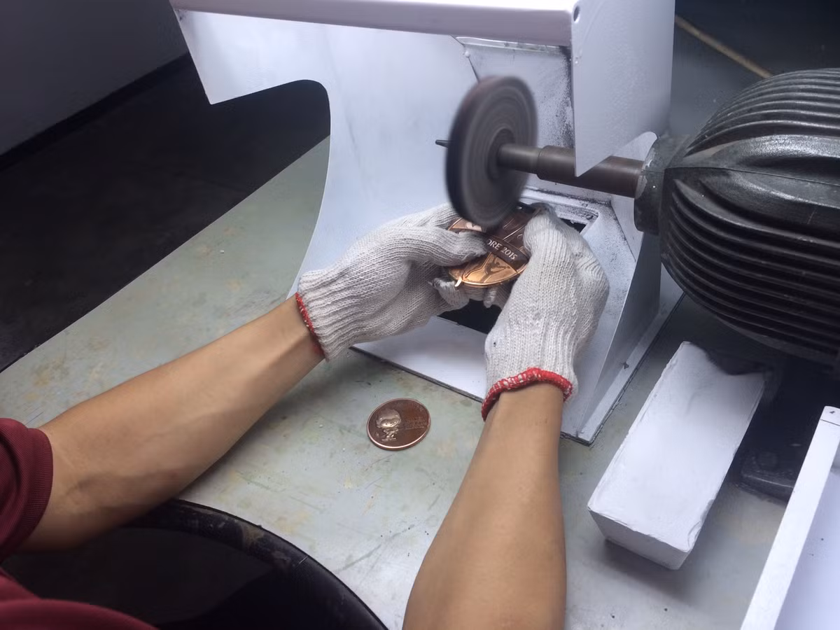 Các góc cạnh của mỗi chiếc huy chương đều được mài giũa một cách tỉ mỉ để đảm bảo độ mịn. Đơn vị thực hiện ELM cho biết, mạ là một trong những bước cuối cùng của quá trình sản xuất và cũng yếu tố quyết định tiêu chuẩn và chất lượng của chiếc huy chương thành phẩm. Quá trình này được thực hiện trong nhà, dưới sự kiểm soát chất lượng nghiêm ngặt.