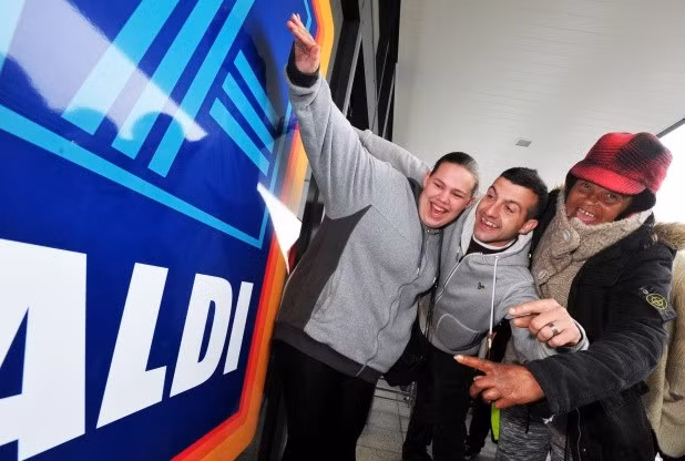Các khách hàng thể hiện niềm vui mừng khôn xiết khi nhận được vé vàng từ siêu thị Aldi sau khi xếp hàng thâu đêm suốt 10 tiếng.