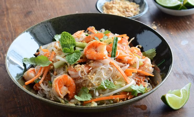 Dưa leo, hành tây và cà rốt vắt thật kiệt nước, thêm tôm và thịt vào, trộn đều rồi để yên 30 phút cho ngấm. Khi dùng cho miến vào trộn đều lên, rắc thêm đậu phộng rang và ngò gai cắt nhỏ là có thể dùng. Ảnh: VnNgon.com.