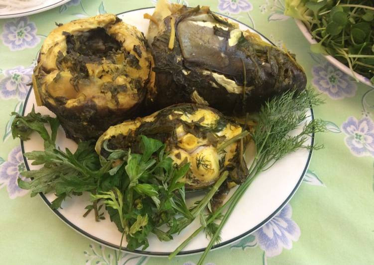 Xếp hành tây dưới nồi cơm, sau đó xếp cá và rau ngải cứu đều trong nồi nấu cơm và đun trong 30 phút là cá chín. Ảnh: cookpad.com.