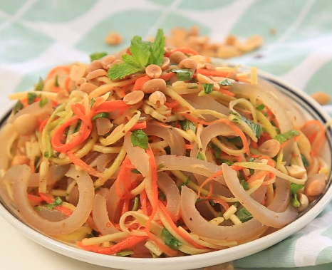 Pha nước mắm trộn gỏi: Trong 1 chiếc bát con, cho 2 thìa đường, 1 thìa ớt bột, 2 thìa nước mắm, 1 thìa nước cốt chanh vào khuấy đều. Trộn bì lợn, xoài xanh, cà rốt với nước trộn và rau thơm, thêm chút lạc rang lên trên. Ảnh: ngocfoody.blogspot.com.