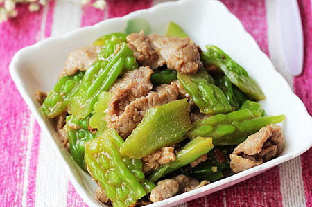 Khổ qua rửa sạch thái lát mỏng. Phi tỏi cho thơm rồi xào thịt bò tới khi chín tái. Rồi để ra đĩa. Sau đó xào mướp đắng hơi chín rồi cho thịt đã xào vào đảo qua vài đũa nữa. Nêm thêm nước mắm và đường. Cho ra đĩa rồi thưởng thức. Ảnh: phunutoday.vn.