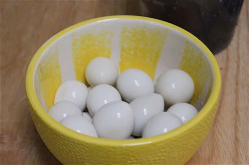 4. Trứng cút sốt cà chua. Nguyên liệu: Trứng cút, cà chua, rau răm, hành lá, đường, mì chính, mắm, tỏi. Trứng luộc lên bóc vỏ. Bắt chảo lên rán đến khi trứng vàng thì để trứng ra đĩa. Ảnh: iLamDep.com.vn.