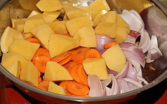 Cho dầu ăn phi thơm số tỏi còn lại rồi cho thịt đã ướp vào xào săn, tiếp theo cho cà chua rồi cho nước và gừng vào hầm thịt cho nhừ. Ảnh: toinayangi.vn.