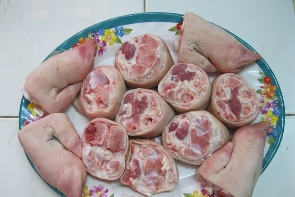 4. Giò heo hầm mía. Nguyên liệu: Bắp giò, khúc mía, nước dừa tươi, cà rốt, củ sắn, cải chua, ngò rí, tỏi băm, xí muội, sa tế tôm, đường, hạt nêm, muối, màu điều. Thịt rửa sạch, ướp với số gia vị trên (trừ màu điều). Để 30 phút cho thịt thấm gia vị. Ảnh: Monngon.tv.