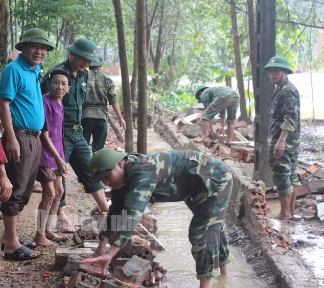 Cán bộ, chiến sĩ Đồn Biên phòng Phú Gia, Đồn Biên phòng Bản Giàng (Biên phòng Hà Tĩnh) giúp đỡ trường dọn vệ sinh sau lũ.
