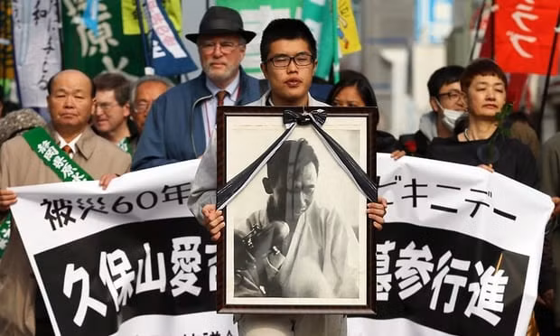 Người dân Yaizu, Nhật Bản xuống đường yêu cầu Mỹ bồi thường cho Kuboyama, giám đốc điều hành tàu đánh cá Lucky Dragon bị thiệt mạng vì nhiễm phóng xạ ở Bikini gây ra