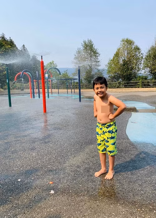 Dù trời lạnh, con trai Ái Châu vẫn nhất quyết chạy ra tắm cho bằng được.