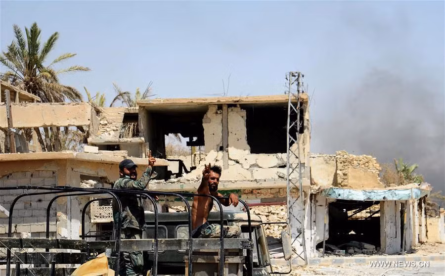 Các binh sĩ Syria giơ tay biểu tượng chiến thắng khi ngồi trên xe ở thị trấn al-Sukhnah sau giải phóng ngày 13/8/2017. Ảnh: THX.