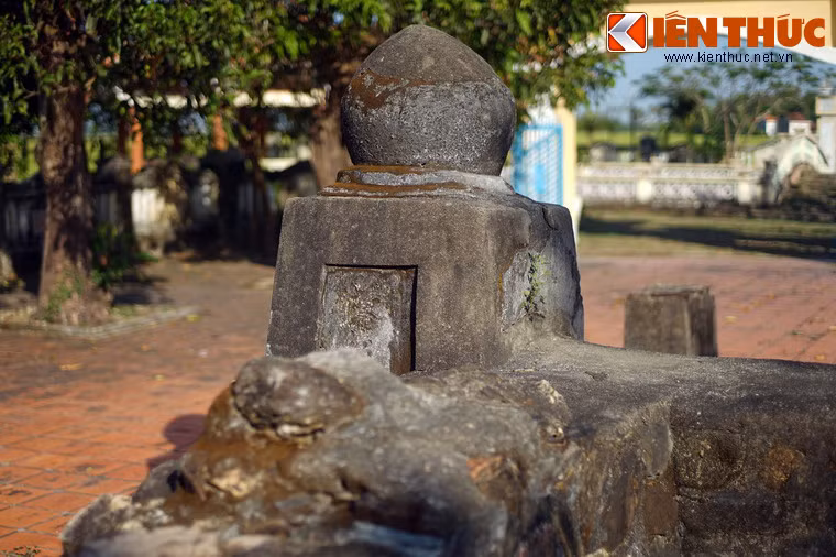 Bốn góc tường bao quanh mộ có bốn cột lớn, đỉnh cột đắp hình búp sen.