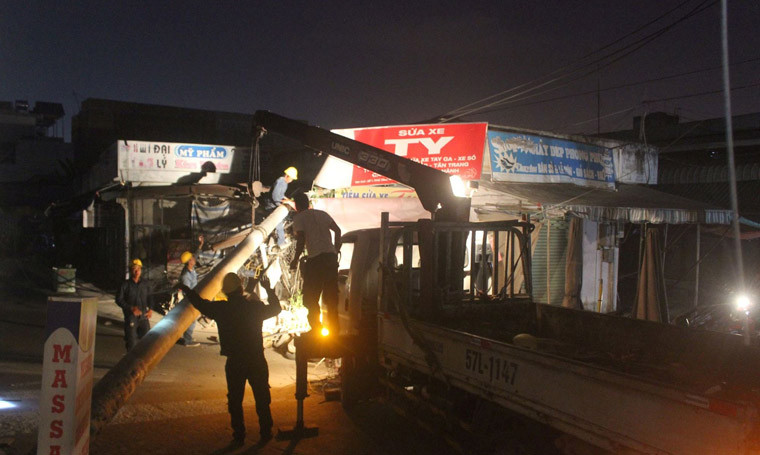 Nhân viên Điện lực Thủ Thiêm khẩn trương khắc phục sự cố gãy trụ điện gây mất điện trên diện rộng ở quận 9, TP HCM tối 11/4.