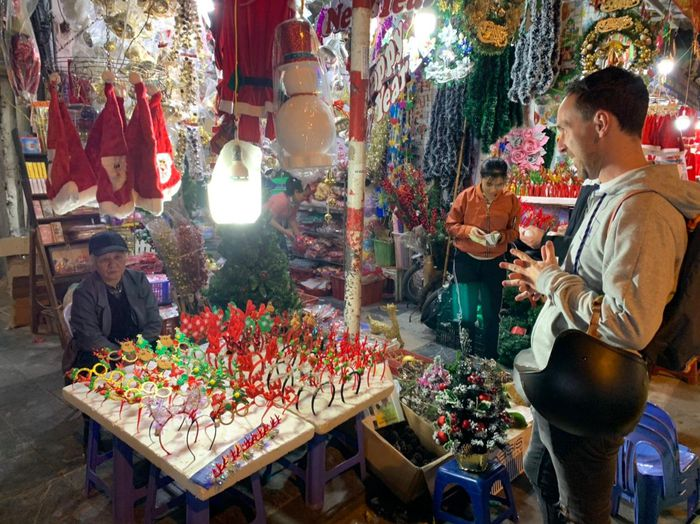 Du khách nước ngoài thích thú với những món đồ đẹp và độc đáo được chủ các cửa hàng trưng ra mặt tiền.