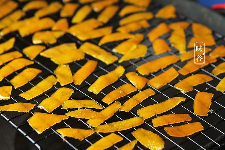 Vớt vỏ cam ra để nguội, chú ý lúc vớt nên dùng vỉ để xếp vỏ cam cách xa nhau một khoảng, như thế các miếng mứt mới không bị dính vào nhau.