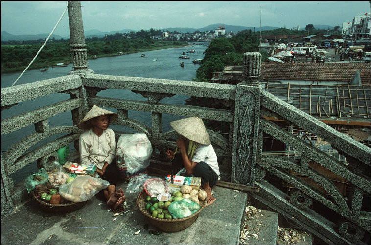 Hai phụ nữ bên bờ sông Ka Long ở Móng Cái, bên kia sông là lãnh thổ Trung Quốc, 1995. Ảnh: Magnumphotos.com