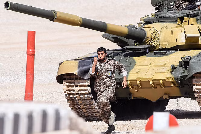 Thành viên kíp lái tăng Iran chạy phía trước xe.