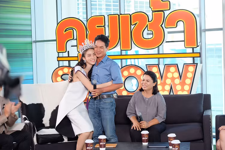 Hoa hậu chuyển giới Yoshi Rinrada Thurapan trong vòng tay cha. Tân hoa hậu thu hút sự quan tâm của dư luận, truyền thông quốc tế bởi nhan sắc không tì vết. Cô lập tức được so sánh với Angelababy hay “thần tiên tỷ tỷ” và là ứng viên nặng ký cho ngôi vị Nữ hoàng chuyển giới Quốc tế diễn ra vào cuối năm. Người đẹp 20 tuổi còn là diễn viên được yêu thích tại Thái Lan. Trang cá nhân của cô có hơn 1 triệu lượt người theo dõi.