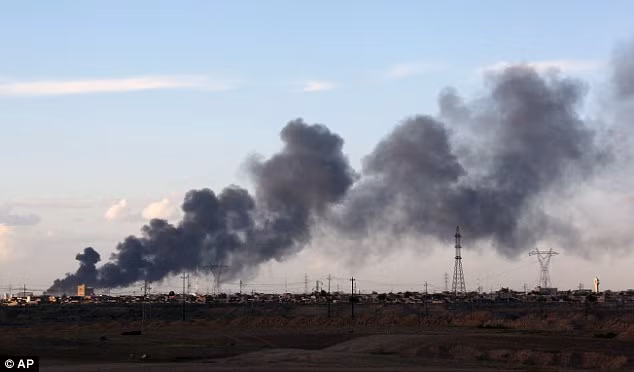 Một cột khói lớn bốc lên sau các cuộc đụng độ. Các đợt phản công của Iraq và lực lượng người Shi'ite từng gặp khó khăn do phiến quân IS gài bom khắp nơi trong thành phố Tikrit.