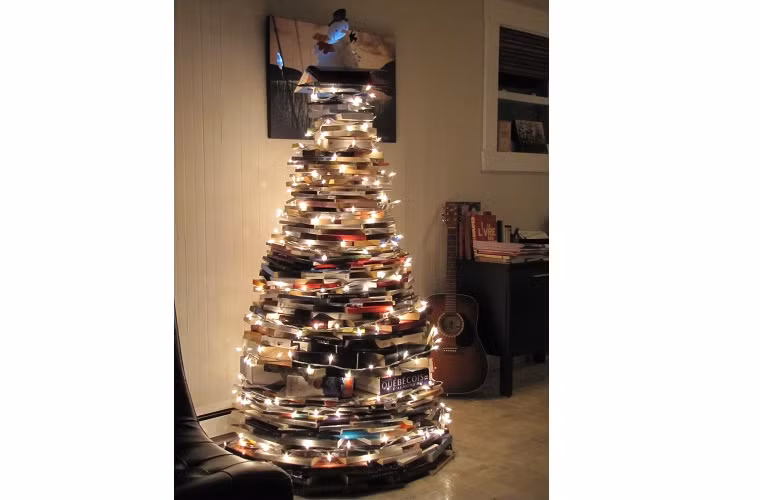  2. Từ những quyển sách: Đối với những người thích đọc sách, thay vì bạn đặt những quyển sách của mình nằm trên kệ hoặc giá như bình thường. Thì dịp Noel, hãy cho chúng được sặc sỡ hơn bằng cách xếp tròn những quyển sách theo từng lớp, nhỏ dần để tạo ra hình dáng cây thông Noel.