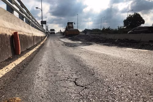 Đoạn sụt lún, trồi nhựa, gồ cao 20cm, kéo dài hơn 10m, nằm ở cả 2 làn ôtô ngay dốc lên cầu vượt Mỹ Thủy, theo hướng từ quận 2 đi quận 7. Trao đổi với PV ngay tại hiện trường, đại diện Khu Quản lý Giao thông đô thị số 2 (Khu 2, Sở GTVT TPHCM, chủ đầu tư) cho biết, việc tạm đóng đường để thi công này nằm trong kế hoạch hoàn thiện cao độ đường đầu cầu vượt theo đúng thiết kế đã trình qua Sở GTVT TP HCM, ngay trước thông xe cầu vượt qua nút giao Mỹ Thủy.