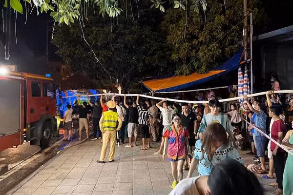 Khi thấy đường ống máy bơm nước quá thấp và có độ nặng, đội PCCC cần đưa lên cao, người dân gần đó đã hô hào tới để chung sức vác ống bơm lên vai giúp chữa cháy. (Ảnh: Thành Phố Móng Cái)