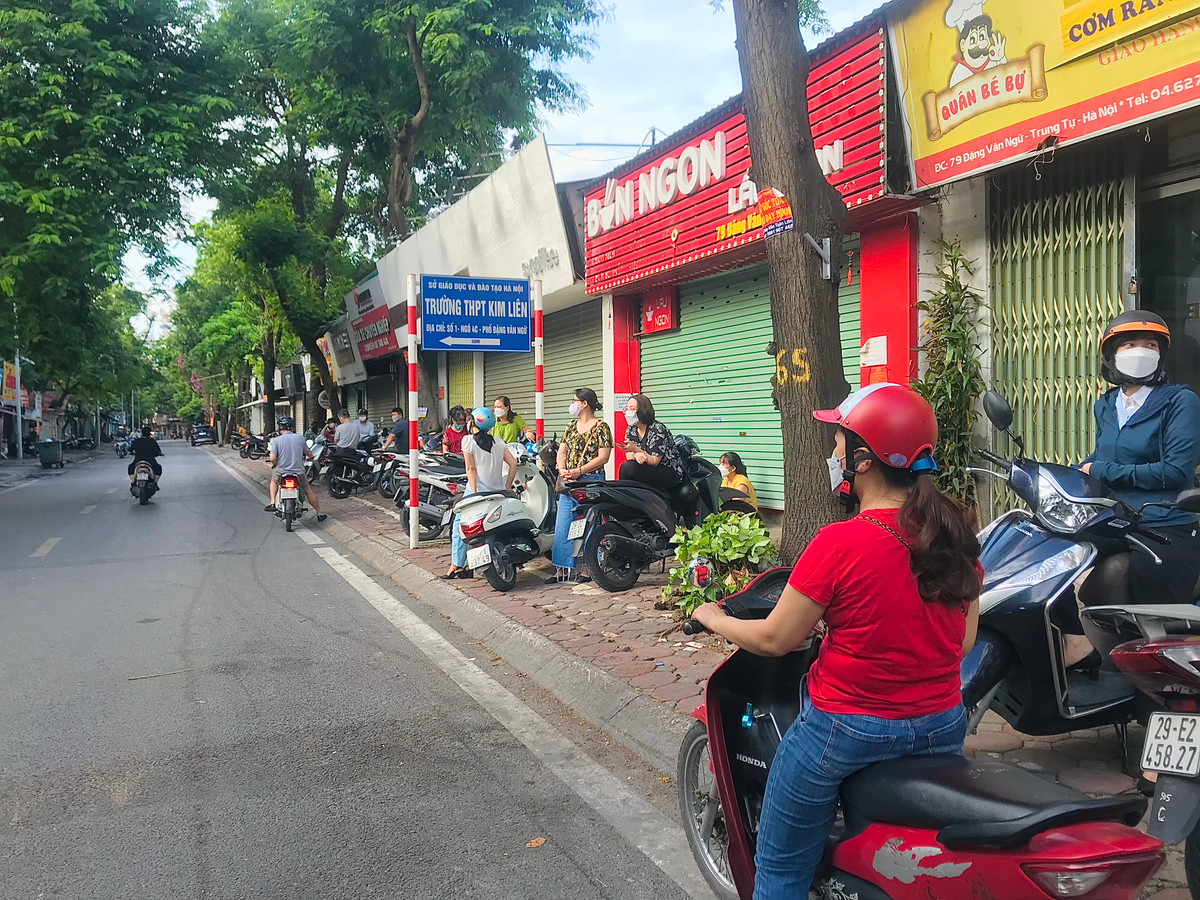 Phụ huynh chờ con em trong giờ thi tại điểm thi THPT Kim Liên (Hà Nội).