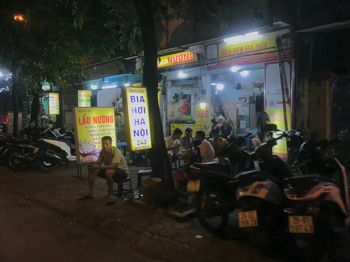 Xe máy, bàn ghế quán nhậu chật kín vỉa hè.