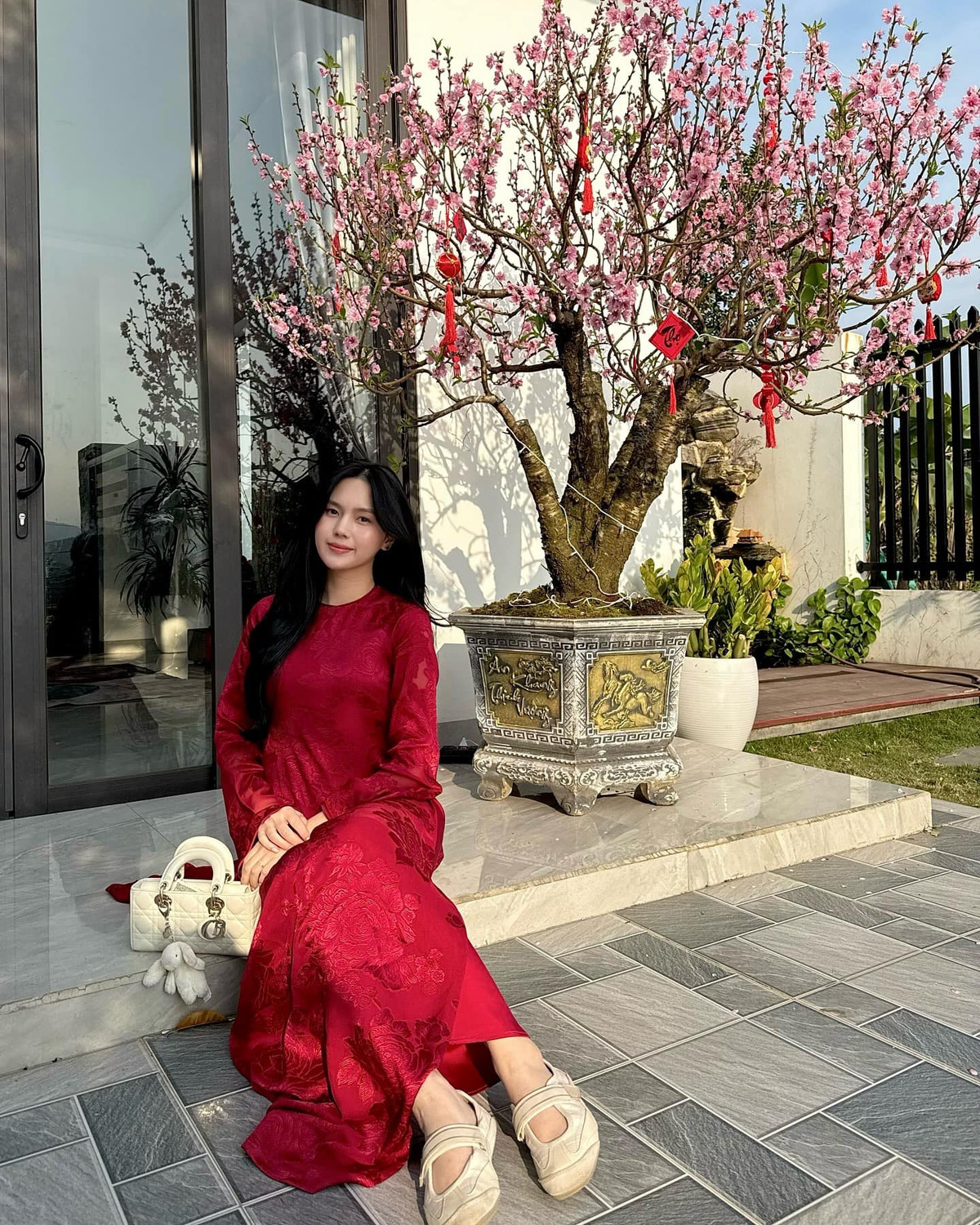 Trong thiết kế áo dài suông đỏ thắm, Tố Uyên khoe nhan sắc đằm thắm, ngọt ngào.