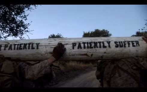 Những người đi quá chậm sẽ bị phạt bằng cách phải mang theo một khúc gỗ nặng 170 pound (khoảng 77kg) trên đó có khắc dòng chữ "Suffer patiently ... patiently suffer" (tạm dịch: Kiên nhẫn chịu đựng) – một trong những khẩu hiệu nằm lòng của những xạ thủ bắn tỉa. Thông thường, bài kiểm tra này sẽ ngốn của các học viên khoảng 8 giờ đồng hồ.