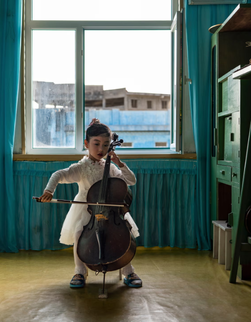 Ảnh chụp một bé gái chơi cello tại trường mẫu giáo Chongam ở Chongjin.