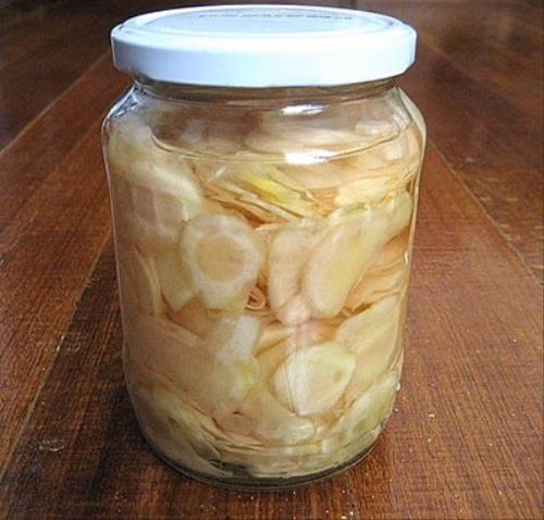 Sau đó, bạn thái gừng thành những lát mỏng, ngâm qua nước muối khoảng 15 phút để cho ráo nước. Ảnh: suckhoegiadinh.