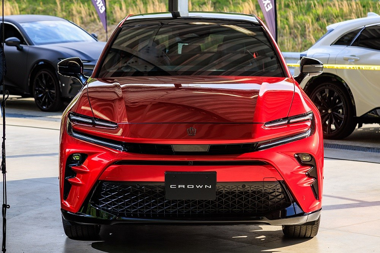 Mũi xe với thiết kế lấy cảm hứng từ cá mập đầu búa của Toyota Crown Sport 2024 sắc sảo hơn so với người anh em Crown Crossover. Trên đầu xe, mẫu SUV hạng trung này được trang bị hệ thống đèn 2 tầng với đèn LED định vị ban ngày kiêm đèn báo rẽ nằm trên và đèn pha LED bên dưới. Ở giữa 2 dải đèn LED định vị ban ngày là lưới tản nhiệt hẹp, tích hợp hộp chứa radar phục vụ các hệ thống trợ lái nâng cao ADAS.