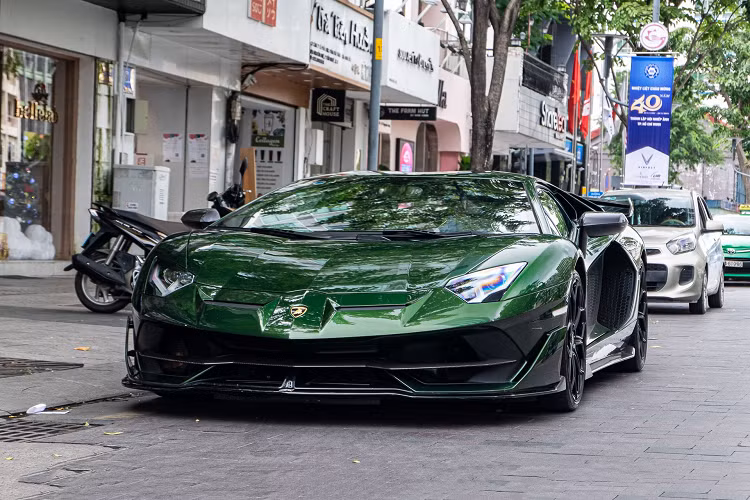 Chiếc Lamborghini Aventador SVJ còn lại cũng độc lạ không kém khi xe sở hữu màu sơn Verde Ermes, được chủ nhân cũ đặt riêng thông qua bộ phận cá nhân hóa Ad Personam của thương hiệu siêu xe Italy. Xe cũng có tùy chọn nhiều chi tiết bằng sợi carbon như ốp gương chiếu hậu, ốp hốc gió động cơ, líp sườn, nắp động cơ. 