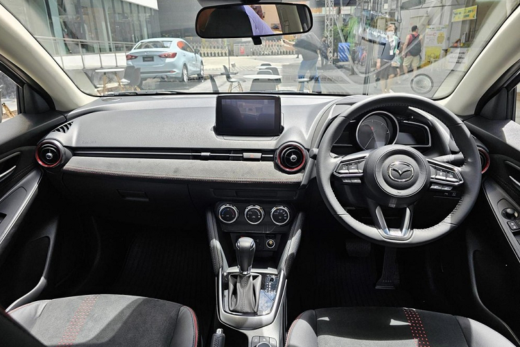 Thêm vào đó là những chi tiết màu cam Racing Orange ở cản trước, ốp gương chiếu hậu, vành la-zăng, đề-can bên sườn... Với phiên bản Clap Pop, Mazda2 2023 lại có những chi tiết sơn màu trắng như lưới tản nhiệt, ốp gương chiếu hậu, nóc và vành la-zăng. Trên nắp ca-pô, cản trước và cửa cốp có thêm họa tiết tòa nhà chọc trời, lấy cảm hứng từ quang cảnh đô thị.